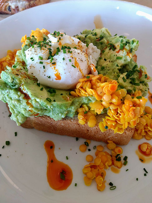 Tostada con aguacate, lentejas en escabeche, huevo escalfado, cebollín y aceite con chile en Bakery Lorraine